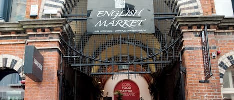 The entrance to the English Market with a sign above the archway.