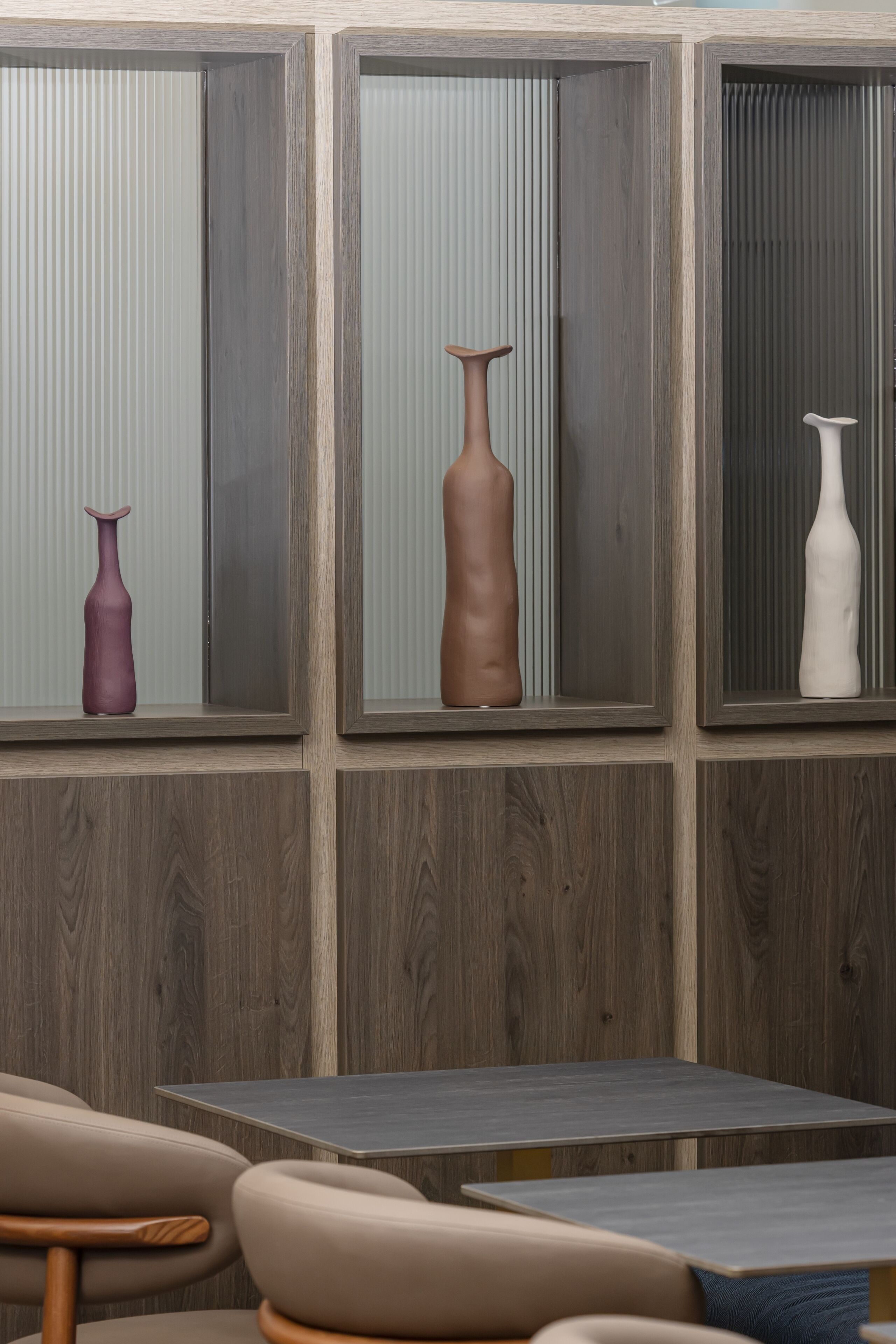 A room with a wooden panel wall, a table, and chairs.