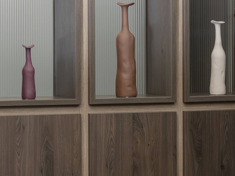 A room with a wooden panel wall, a table, and chairs.