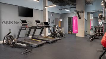A gym with treadmills, stationary bikes, and weight machines.