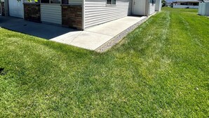 A single-story mobile home with a front porch, a stone foundation, and a clear blue sky in the background. - NEW LISTING- Brookwillow Retreat (Grand Junction)