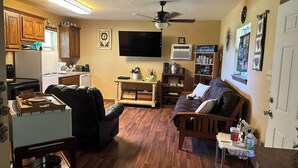 A compact living space with a kitchen, dining area, and seating area. - Cozy cabin in Glen Rose with AC, WiFi, Close to all major attractions! (Glen Rose)