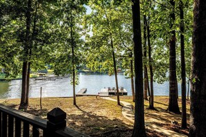 A lakeside park with a wooden dock and seating area.