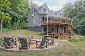 A two-story house with a wooden deck and a circular seating area with Adirondack chairs. - Oasis of Sautee, 4-bedroom loaded house in Clarkesville, 9 miles form Helen Ga (Clarkesville)