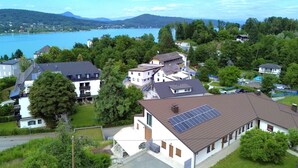 A residential area with houses, a lake, and mountains in the background. - Sunshine view 3 by Interhome (Reifnitz)