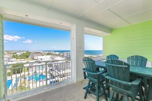 A balcony with a view of a residential area and a pool. - Sojourns Beach Views & Pool Family Home Sleeps 9 (Virginia Beach)