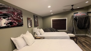 A hotel room with two beds, a ceiling fan, a window with blinds, and artwork on the walls. - Outdoor Oasis and Pickleball Paradise: Fishing, Paddle-boarding, Swimming (Augusta)