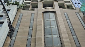 A high-rise building with a modern architectural design, featuring large windows and a prominent entrance.