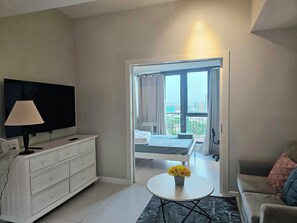 Standard Apartment, City View | Living area | 55-inch Smart TV with digital channels