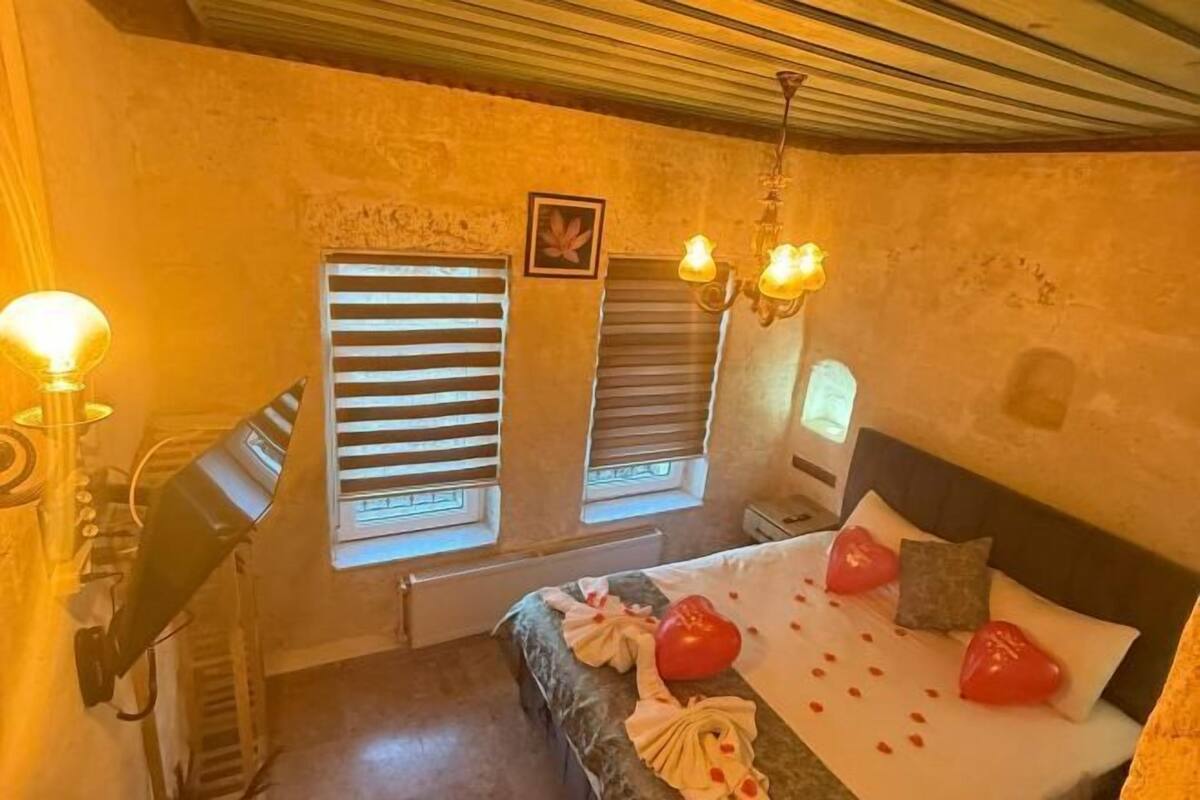 A room with a bed, a desk, and a chair.