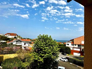 A residential area with houses, a tree, and a clear sky.