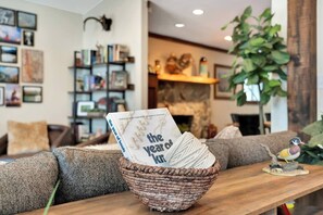 A cozy living room with a fireplace, a bookshelf, and a decorative bird statue.