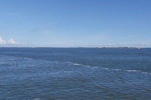A coastal view with calm waters and a distant shoreline. - Holiday Apartment South Beach (Borkum)