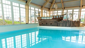 An indoor swimming pool with a wooden ship structure in the background. - Holiday Home With Sauna Near Amsterdam (Uitdam)