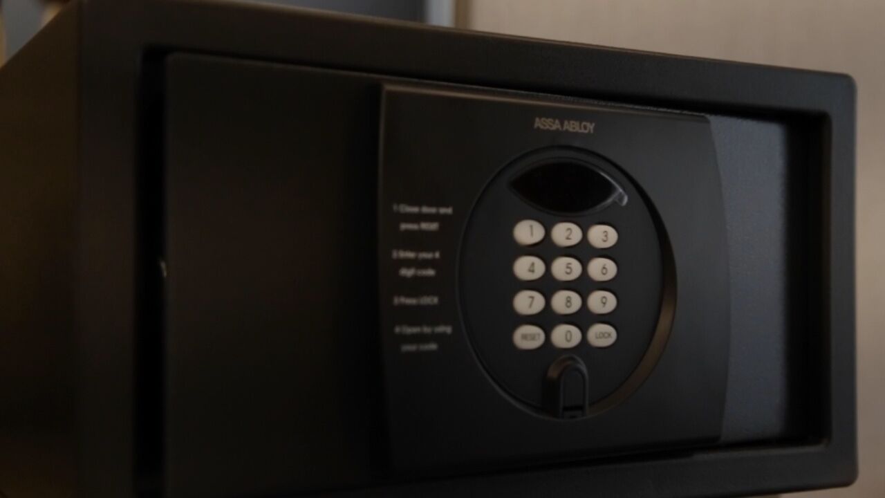 A black microwave with a keypad and a digital display.