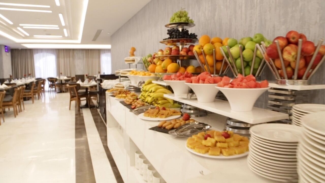 A buffet with various fruits and desserts.