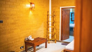 A bathroom with a wooden bench, a bamboo ladder, and a towel rack. - 90 Degrees Ella (Ella)