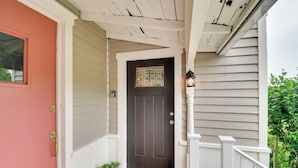 A front porch with a dark brown door, a welcome mat, and a small potted plant. - Restored Ovid Church Near Cayuga Lake Wine Trail (Ovid)