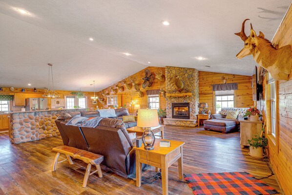Cozy living area with a sofa, bench, and stone fireplace, perfect for relaxing.