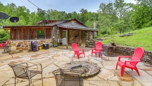 A rustic cabin with a stone exterior, a fire pit, and red Adirondack chairs. - Mountain-view Cabin on Farm: 3 Mi to Town & Shops (Mountain View)