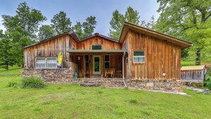 A rustic wooden cabin with a stone foundation, a porch, and a small front yard. - Mountain-view Cabin on Farm: 3 Mi to Town & Shops (Mountain View)