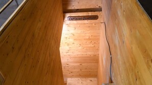 A wooden staircase leading to a lower level, with a sign reading "CAPTAINS QUARTERS" above it.