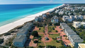 A coastal residential area with beachfront properties, a central green space, and a clear view of the ocean. - Magnolia by the Sea, Priv Beach, Pool (Santa Rosa Beach)