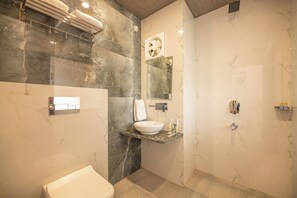 A bathroom with a marble sink, a toilet, and a shower. - Hotels Vibes  (Vikasnagar)