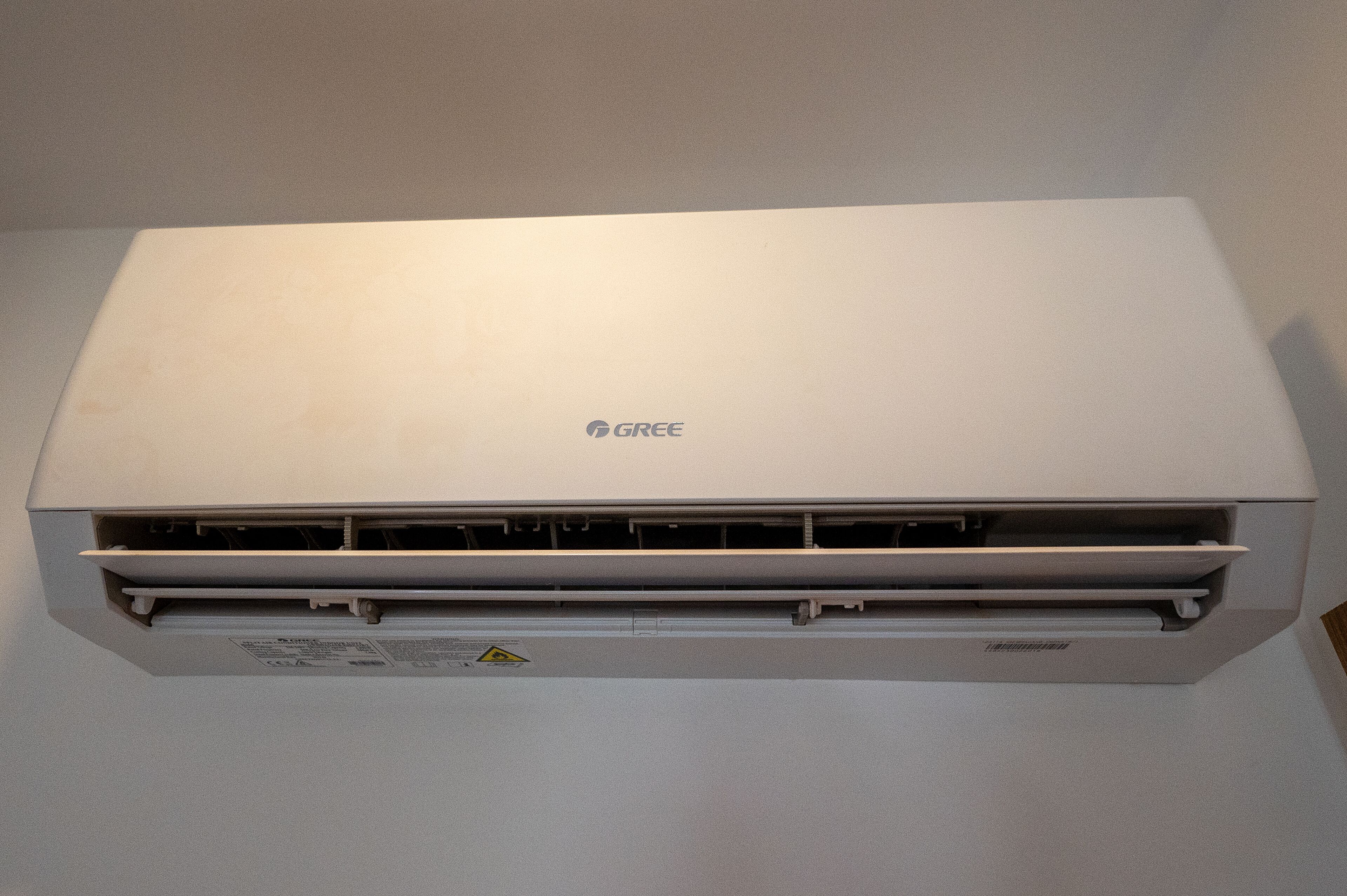 A white GREE air conditioning unit mounted on a wall.
