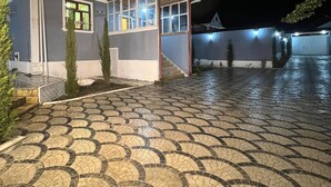 Un edificio con vestíbulo de baldosas y una pequeña zona cubierta con ventanas.