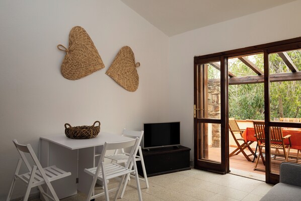 Apartment, Garden View | Living area | 35-inch TV with digital channels