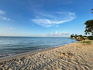A beach with clear skies and calm waters. - Aqua Dream Hideaway at Aquatika Beach Villas (Loiza)
