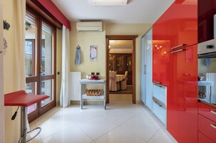Deluxe Apartment | Private kitchen | Full-size fridge, stovetop, electric kettle, cookware/dishes/utensils