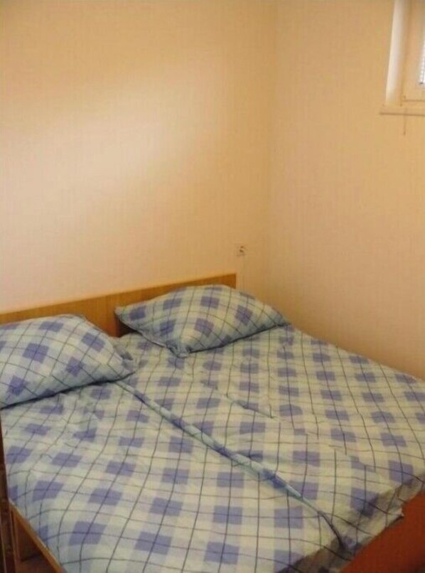 Cozy retreat with a single bed and a convenient power outlet nearby.