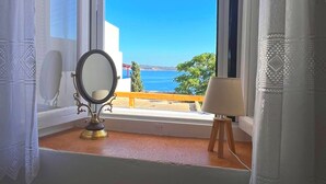 A room with a window overlooking a scenic view. - Cycladic Home with a view  - 2 min walk from the beach!  (Adamantas)