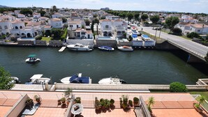 A coastal town with a marina, white buildings, and a bridge. - 224-Apartment with view on marina , pool and parking (Empuriabrava)