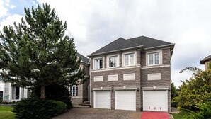 A two-story house with a stone facade, a large tree in the front yard, and a red pathway leading to the garage. - 25% Fall OFF, Luxury 3 Bdrms, 2 Baths, 2 Prk (Richmond Hill)