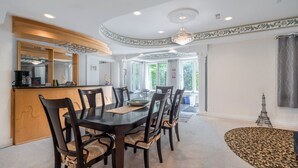 A dining area with a round table, six chairs, a wooden sideboard, and a chandelier. - 25% Fall OFF, Luxury 3 Bdrms, 2 Baths, 2 Prk (Richmond Hill)