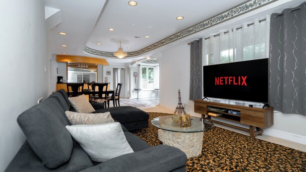 A modern living room with a large flat-screen TV, a sofa, a glass coffee table, and a patterned carpet. - 25% Fall OFF, Luxury 3 Bdrms, 2 Baths, 2 Prk (Richmond Hill)