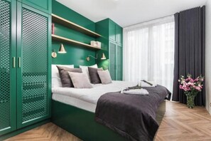 Relax in this serene bedroom with a comfortable bed, bedside table, and stylish wardrobe.