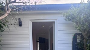 A house entrance with a door leading to an interior space. - Cozy and modern studio in prime location-perfect for your getaway (Brighton and Hove)