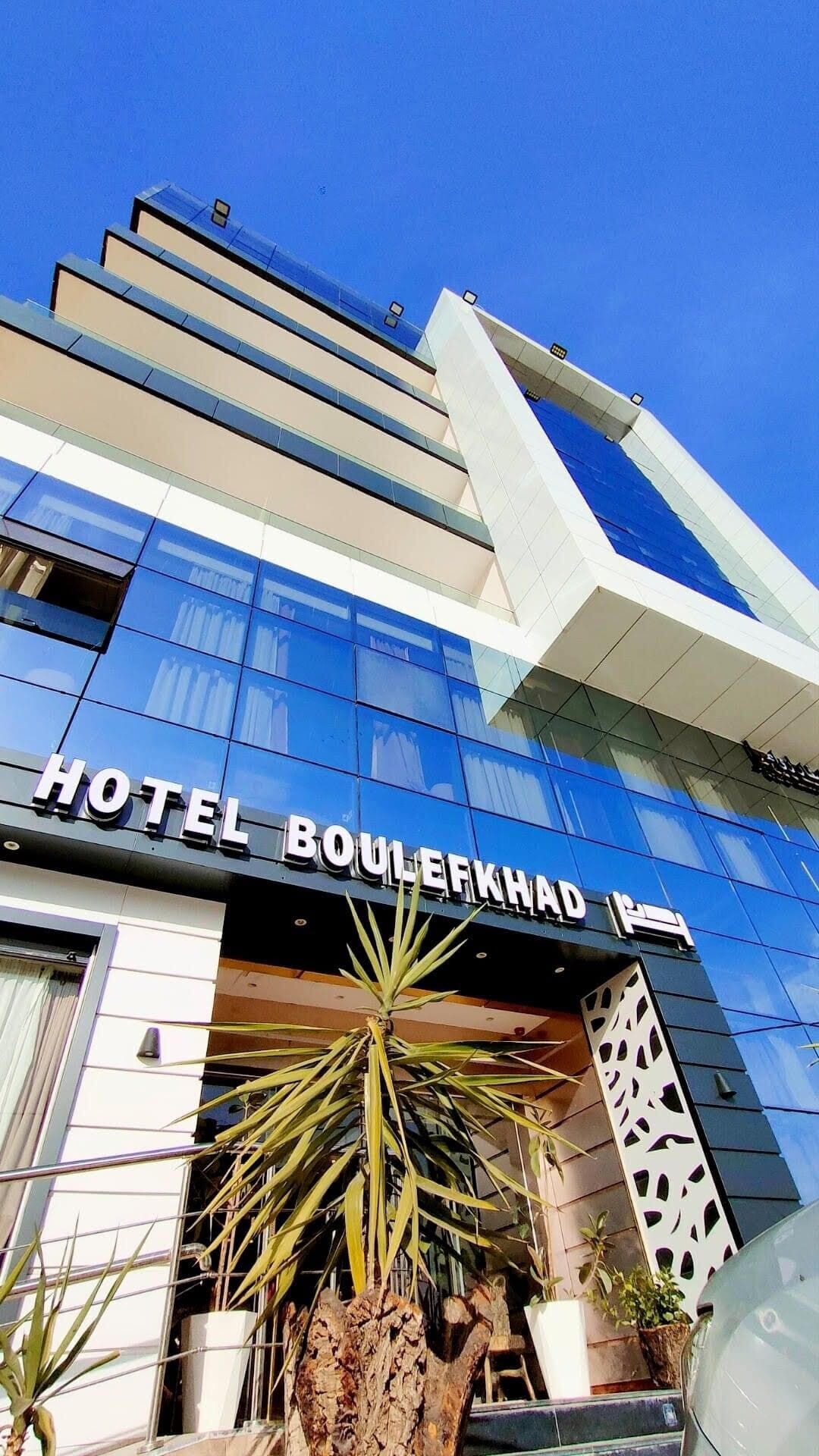 A modern hotel facade with the name "HOTEL BOULERKHAD" prominently displayed.