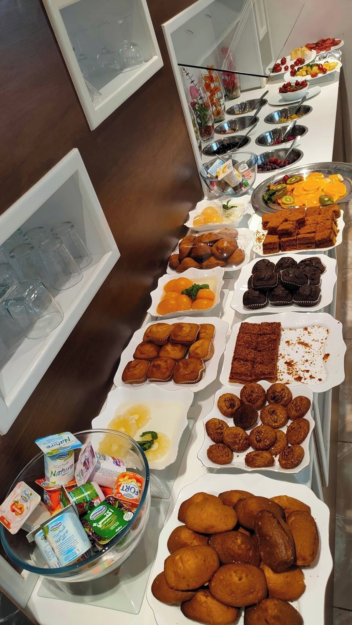 A buffet table with various food items and beverages.