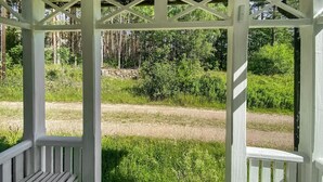 A white wooden gazebo with a lattice roof, surrounded by lush greenery and a dirt path. - Awesome home in Alsterbro with WiFi (Alsterbro)
