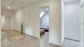 A modern, well-lit room with a skylight, a bed, and a small rug. - 3 bedroom gorgeous apartment in Großenbrode OT Lütjenb (Großenbrode OT Lütjenb)