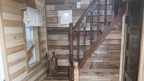 A wooden interior with a staircase, a window, and a door. - "Ridge Haus" tiny cabin on the creek at Waldbaden (Athens)