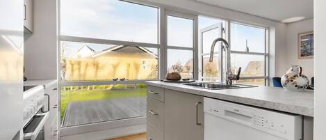 Fridge, stovetop, dishwasher, coffee/tea maker