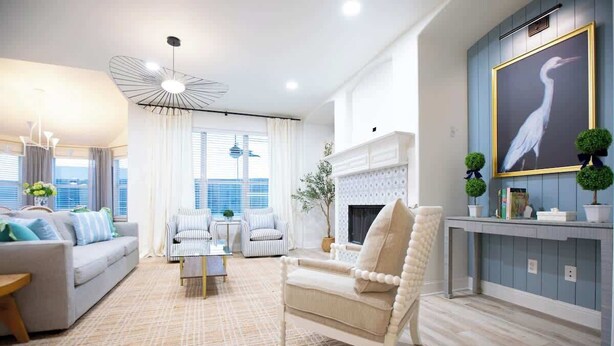 A modern living room with a fireplace, a sofa, armchairs, and a dining table. - Huge 4BR w/ Pool + Grill | Near Lakes and Harbor! (Royse City)