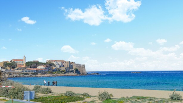 A coastal town with a prominent castle-like structure, sandy beach, and clear blue sea. - Lovely apartment in Calvi with WiFi (Calvi)