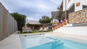 A swimming pool with lounge chairs and a stone wall. - Ref. 494261 (Motril)